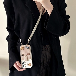 White iPhone case with plush bear card holder and crossbody strap worn by a model