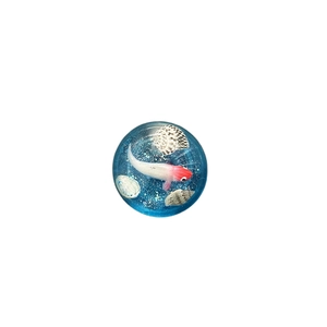 Blue sphere phone grip featuring a miniature koi fish and seashells in clear resin