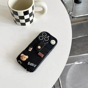 Close-up of black braided iPhone case featuring 3D cartoon bear charms and card holder slot