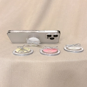 Detail showing glittery PU silver ribbon bow pop socket phone stand for women