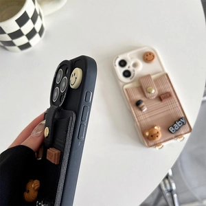 Detail of iPhone case with fabric card holder and 3D bear coffee accessories