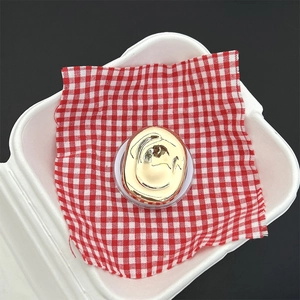 Macro view of bright gold irregular geometric magnetic phone holder in creative art style
