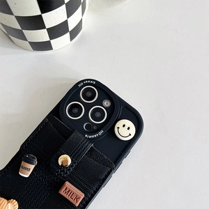 Detail of iPhone case featuring a black fabric pocket with coffee and chocolate charms