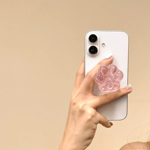 Nahaufnahme einer rosa Glitzer-Katzenpfote Handyhalterung an einem weißen Smartphone