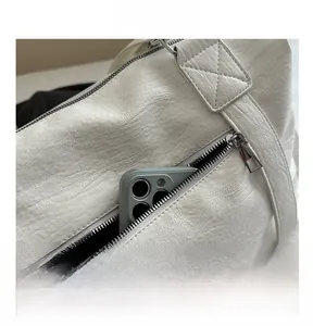 Close-up of white lychee textured tote bag featuring a functional front zipper pocket