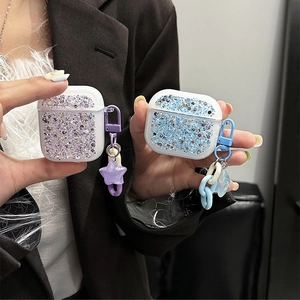 Close-up of glitter AirPods case with star pendant and acrylic chain in blue and purple