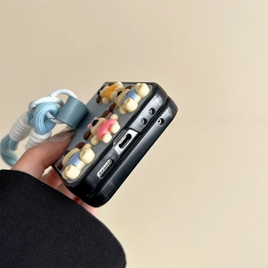 Detail view of cartoon puppy leather case for foldable phones with wrist strap
