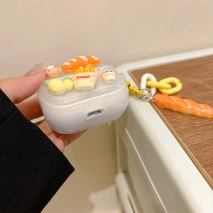 Detail of 3D bread and fries motifs on a glittery silicone case for AirPods