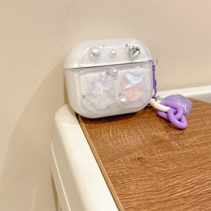 Macro view of AirPods Pro case with glitter finish, pearls, stars and heart rhinestones