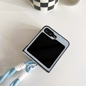 Premium light blue pebbled leather folding phone case with a stylish braided lanyard strap