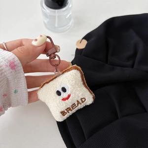 Gros plan d'un mignon porte-clés pain en peluche avec un sourire brodé détail