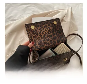 Interior view showing capacity for phone and wallet in leopard print crossbody bag