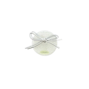 Sparkly silver glitter phone grip with woven bow tie design on white background