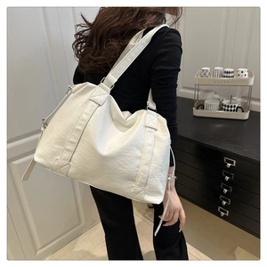 Detailed back view of a white minimalist tote bag with smooth faux leather texture