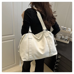 Detail of white lychee texture tote bag with adjustable strap and large capacity design