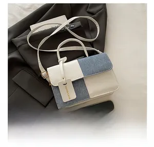Detail of color-block mini square bag with beige leather and blue denim texture