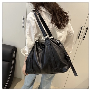 Detailed view of black pleated PU leather tote bag with wide straps for casual daily use