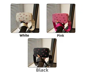 Detailed view of cute cherry print crossbody bags in white, pink, and black color options