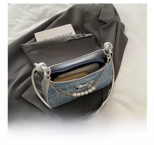 Interior view showing capacity of blue glitter handbag with phone and long wallet