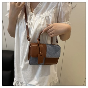 Fashionable brown leather and grey felt patchwork handbag with decorative tag for women