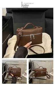 Detail of lychee pattern coffee brown handbag with adjustable strap and metal zippers