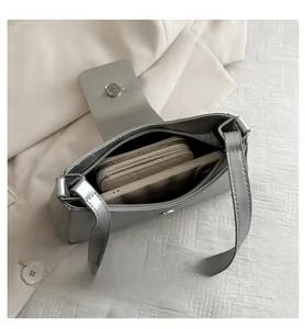 Interior view of silver baguette bag showing capacity for smartphone and wallet