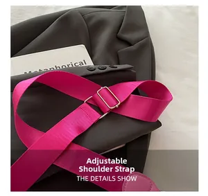 Detail of adjustable rose pink woven shoulder strap with premium gold metal buckle