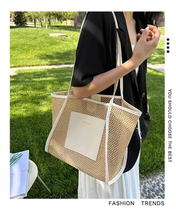 Detail of woven tote bag featuring white leather patch and fashion logo on summer grass