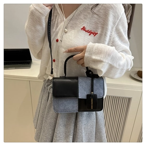 Chic patchwork crossbody bag styled with a white knit top and pleated grey skirt