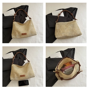 Detail of hand-woven straw beach tote with leather strap and fashion label detail