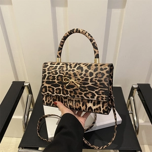Leopard print crossbody bag with gold bow clasp and round handle for summer 2025