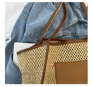 Detail of woven straw tote bag featuring leather trim and fashion brand patch