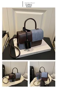 Detail of coffee and blue contrast stitching crossbody bag with a fashion tag