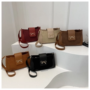 Detailed display of vintage saddle bags in five colors with golden bow hardware