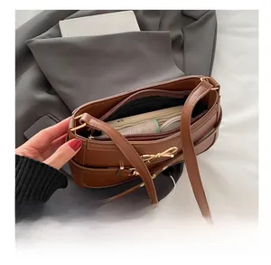 Detail view of the brown leather shoulder bag interior showing spacious storage capacity