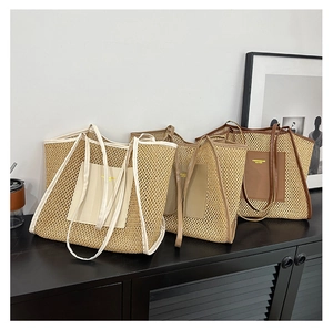 Close-up of woven tote bags in cream, khaki and caramel colors with PU leather patches
