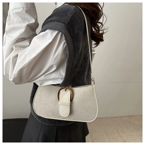 Close-up of beige textured underarm bag with white leather trim and gold buckle