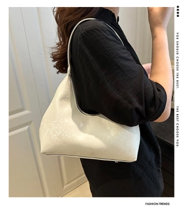 Side view of elegant cream hobo bag with snakeskin texture and fashion bag logo