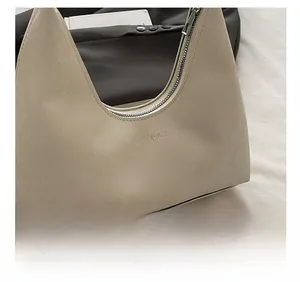 Detail of cream faux crocodile embossed leather texture on a stylish fashion tote bag