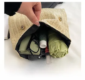Interior detail of the woven clutch bag with magnetic closure and large storage capacity