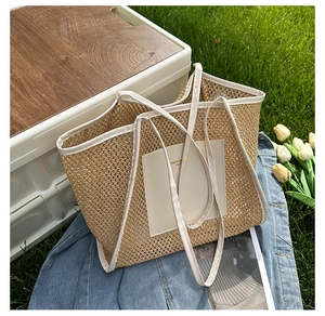 Close-up of beige woven tote bag with faux leather handles on grass for a picnic look