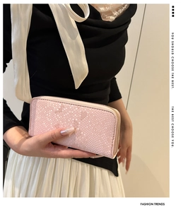 Macro detail of pink snakeskin pattern texture on elegant wallet with metal zipper