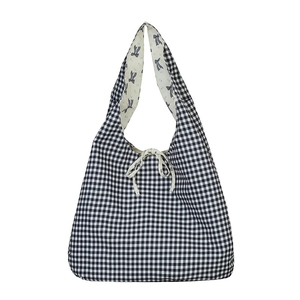 Classic black and white gingham tote bag featuring blue bow print lining and ribbon tie