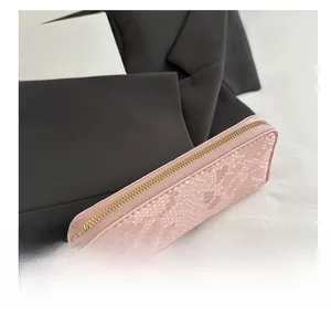 Detail of pink long wallet with snakeskin embossing and premium gold zipper closure