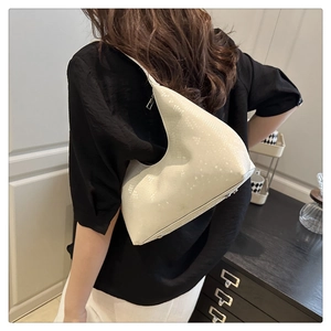 Close-up of off-white faux leather underarm bag with elegant snakeskin texture