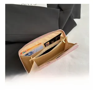 Interior detail of long quilted wallet showing multi-card slots and coin pocket