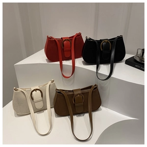 Detail of four retro underarm bags in red, black, beige, and brown with metal buckles
