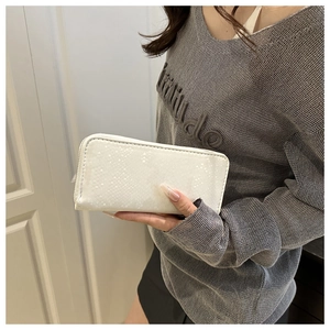 Detailed close-up of white embossed leather long wallet with high-quality metal zipper