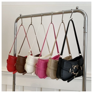 Detail view of stylish underarm bags in six colors with elegant metal bow charms