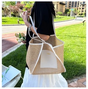 Detail of the woven tote bag showing the white leather pocket and fine knit texture